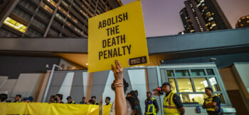 Attivisti di Amnesty International con cartellone in mano "Abolire la pena di morte".